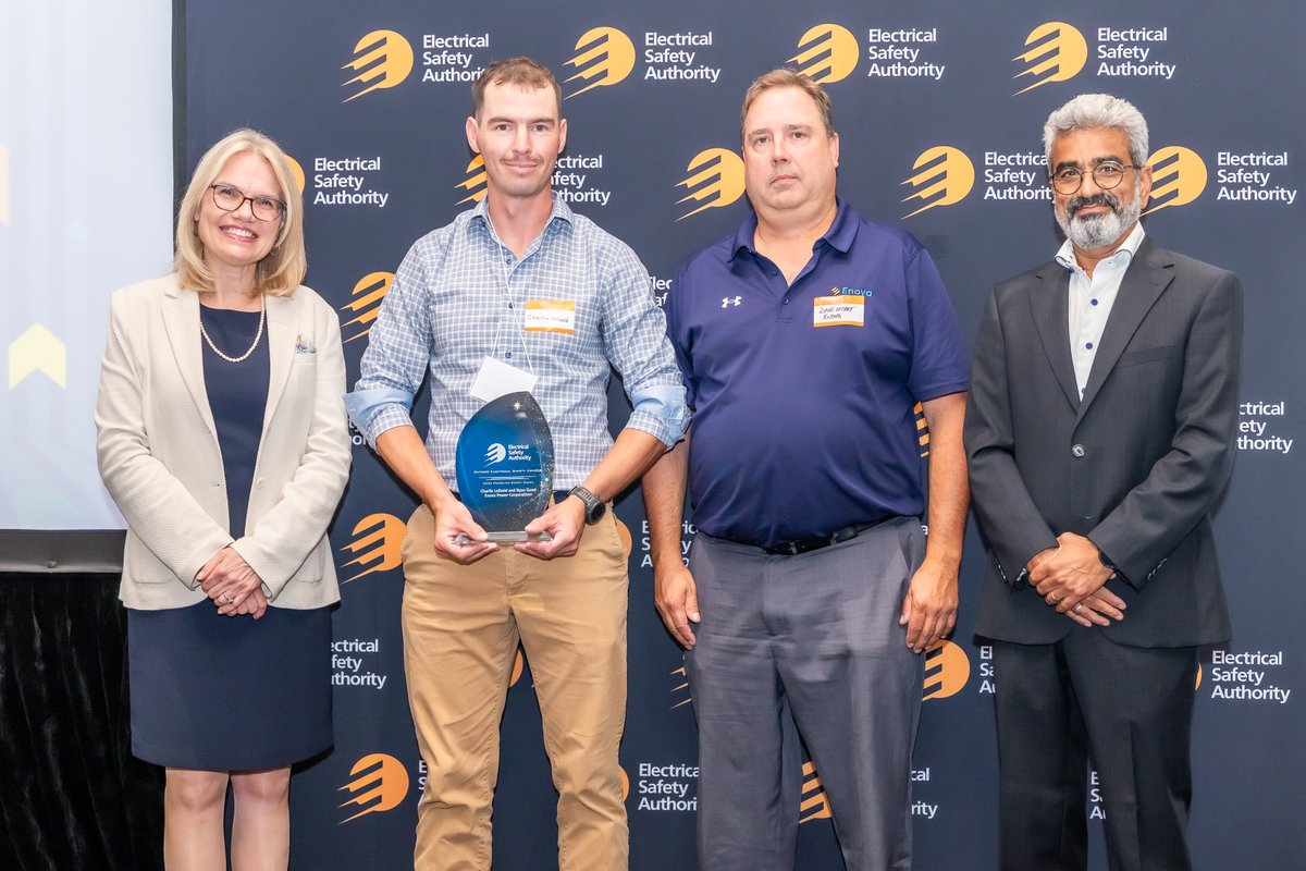 Charlie Leibold, Powerline Technician, and Dave Smart, Distribution Superintendent, accept the 2026 Powerline Safety Award from Josie Erzetic and ESA Board Chair Arjan Arenja. Not pictured is co-award winner Ryan Good.
